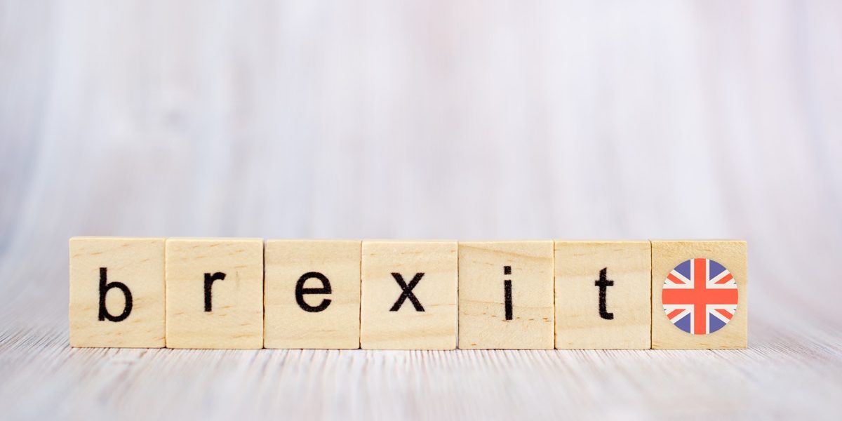 Brexit concept. Brexit word written on wood blocks with British flag. Brexit text on wooden table for your desing